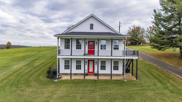 view of front of house with a porch and a front lawn