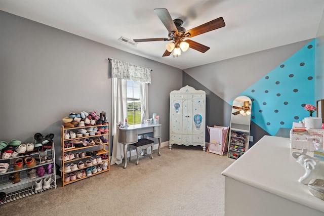 carpeted bedroom with ceiling fan, visible vents, and lofted ceiling