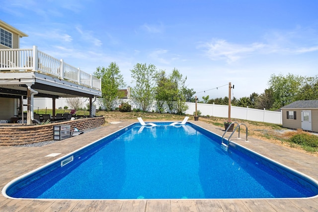 view of swimming pool featuring a patio, a fenced in pool, a fenced backyard, and a deck