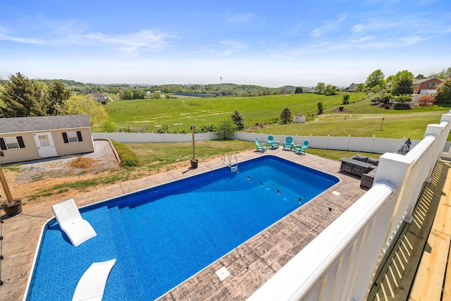 view of pool with an outdoor structure, a fenced backyard, a patio area, and a fenced in pool