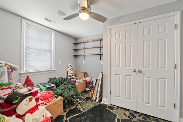 interior space featuring a ceiling fan and visible vents