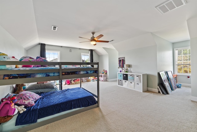 bedroom with visible vents, carpet floors, vaulted ceiling, and multiple windows