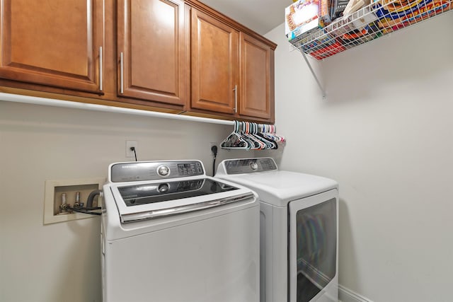 laundry room with cabinet space and washing machine and clothes dryer