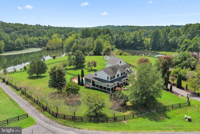 birds eye view of property with a rural view, a water view, and a wooded view