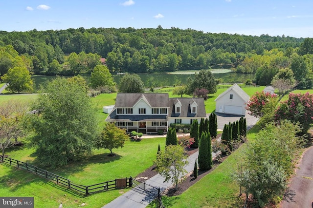 birds eye view of property with a rural view and a wooded view