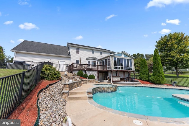 view of pool featuring a deck, a patio area, a fenced backyard, and a sunroom