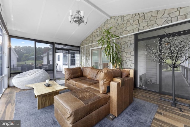 sunroom featuring lofted ceiling with beams and a notable chandelier