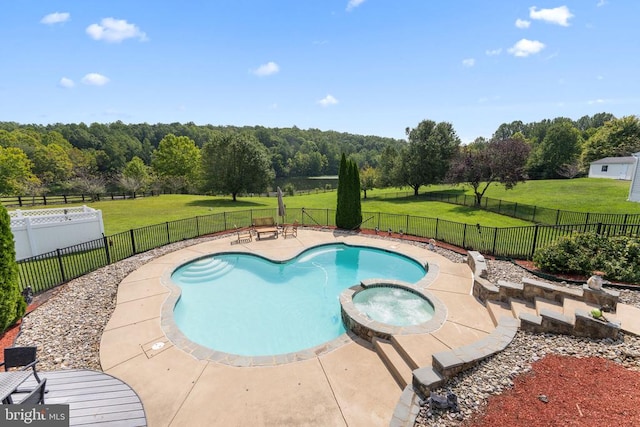 view of pool featuring a fenced backyard, a pool with connected hot tub, a patio, and a yard