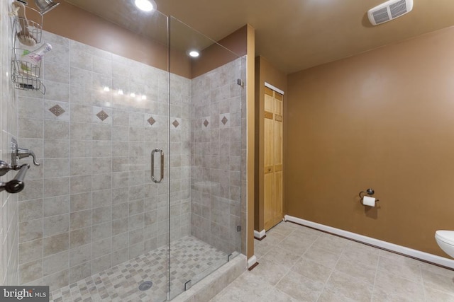 full bath with visible vents, baseboards, toilet, tile patterned flooring, and a shower stall