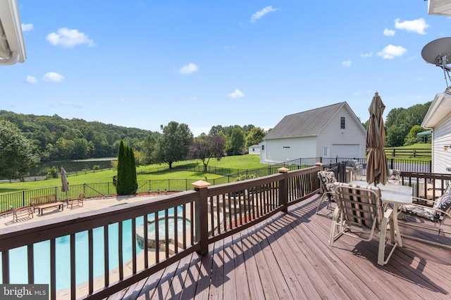 wooden terrace featuring a lawn, a fenced backyard, and a fenced in pool