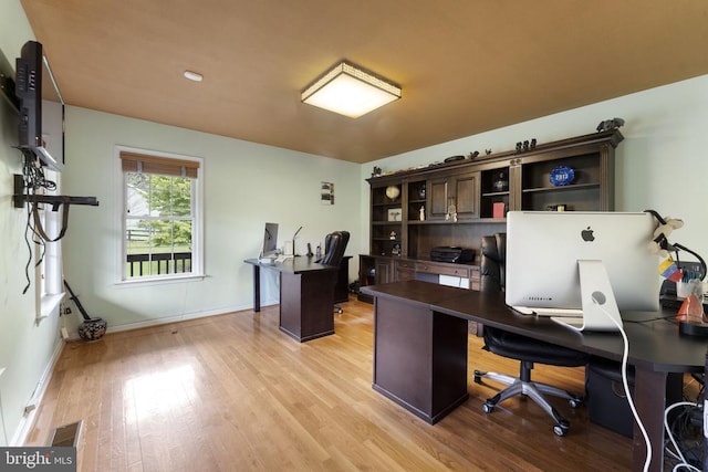 office with visible vents, light wood-style flooring, and baseboards