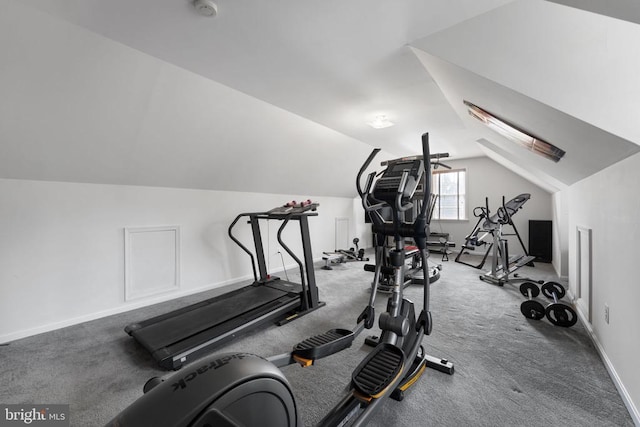 exercise room featuring lofted ceiling and baseboards