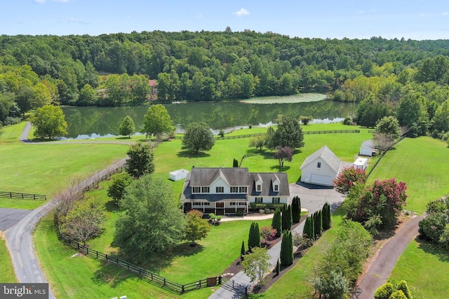 drone / aerial view featuring a water view and a view of trees