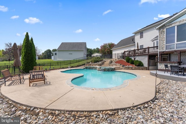 view of pool with a patio, a fenced backyard, and a pool with connected hot tub