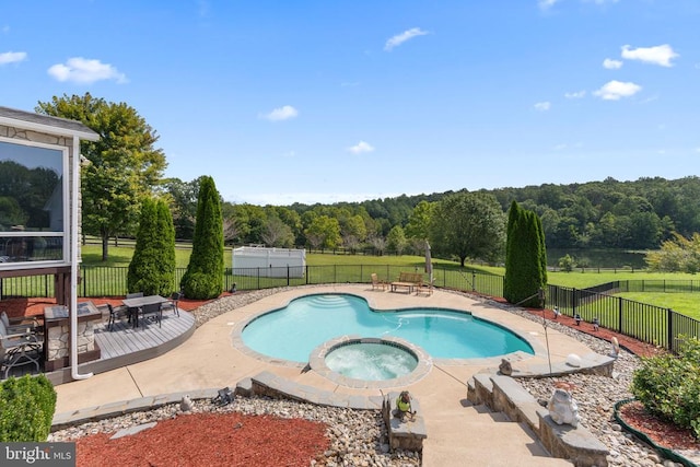 view of swimming pool with a deck, a patio area, a fenced backyard, and a pool with connected hot tub