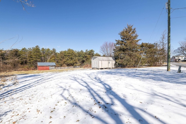 view of yard with a storage shed and an outbuilding