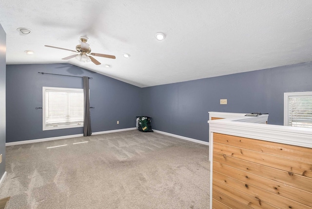 bonus room featuring carpet floors, plenty of natural light, vaulted ceiling, and baseboards