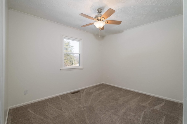 unfurnished room with carpet, visible vents, and baseboards