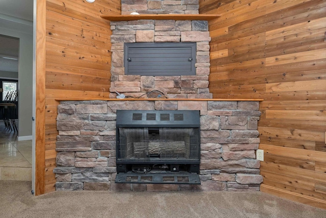 details featuring wooden walls, a fireplace, and carpet flooring