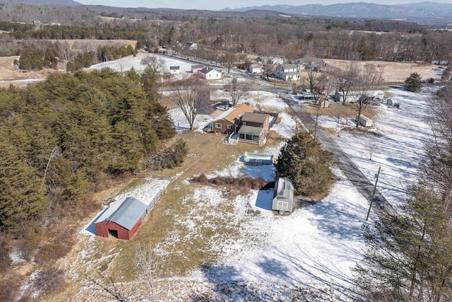 birds eye view of property with a forest view and a mountain view