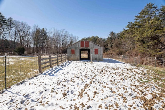 view of outbuilding featuring fence and an outdoor structure