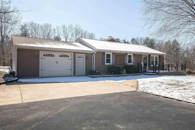 ranch-style house featuring driveway and an attached garage