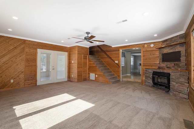 unfurnished living room featuring stairs, visible vents, french doors, and ornamental molding