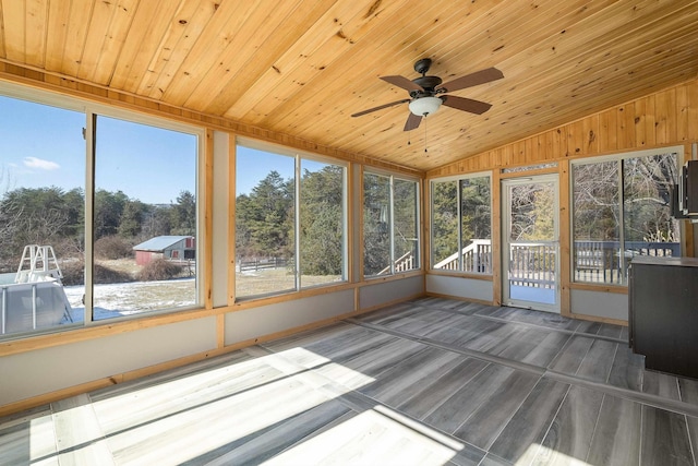 unfurnished sunroom with wooden ceiling, vaulted ceiling, and a ceiling fan