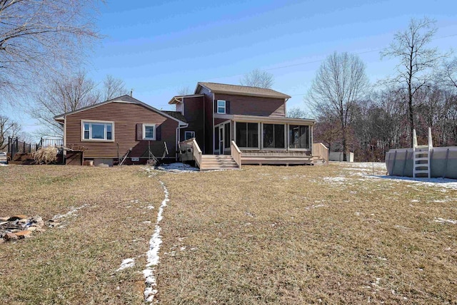 rear view of house featuring a sunroom