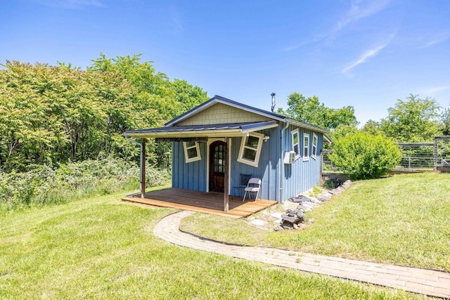 bungalow-style home featuring a front lawn, board and batten siding, and cooling unit