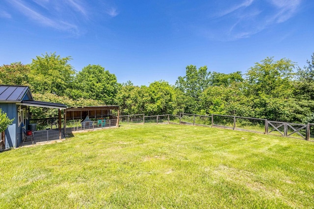 view of yard with an outdoor structure and fence