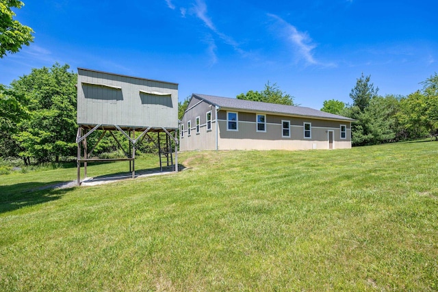 back of house with a lawn