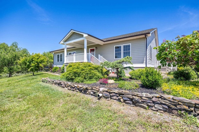 view of front of property featuring covered porch and a front yard