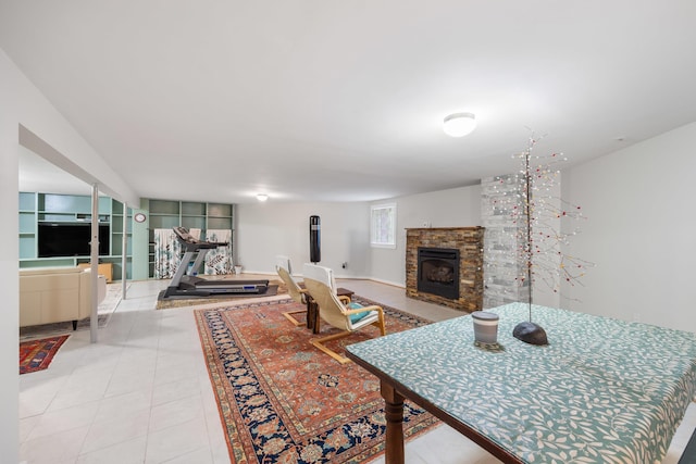 living room with a fireplace and tile patterned floors