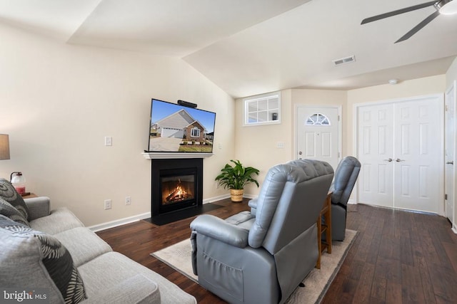 living room featuring visible vents, lofted ceiling, a ceiling fan, and hardwood / wood-style flooring