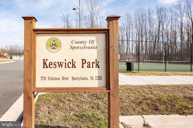 community / neighborhood sign featuring fence