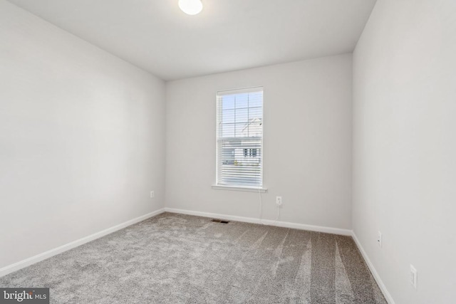 carpeted empty room with baseboards and visible vents