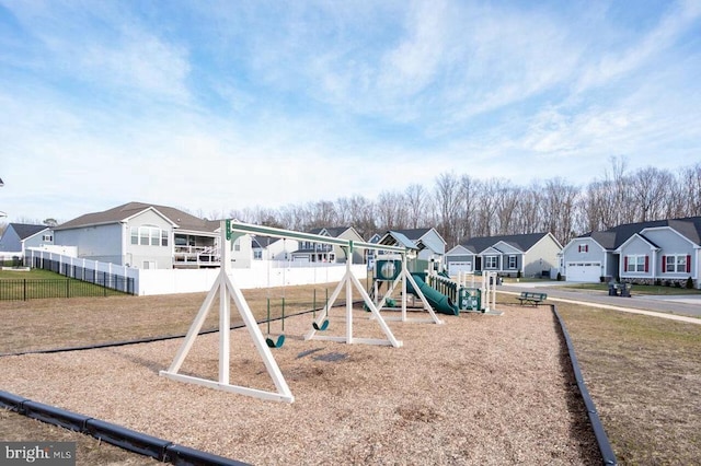 community jungle gym featuring a residential view and fence