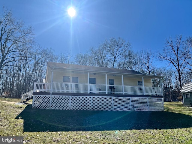 rear view of property featuring a porch