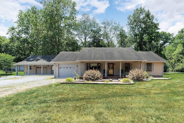 single story home featuring a porch, a garage, and a front yard