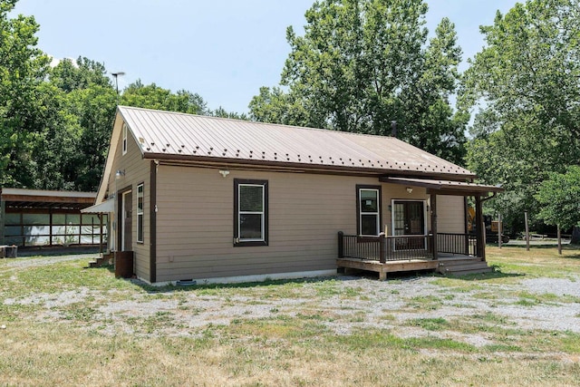 exterior space featuring central AC unit and a front yard