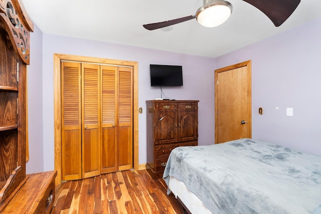 bedroom featuring hardwood / wood-style flooring, a closet, and ceiling fan