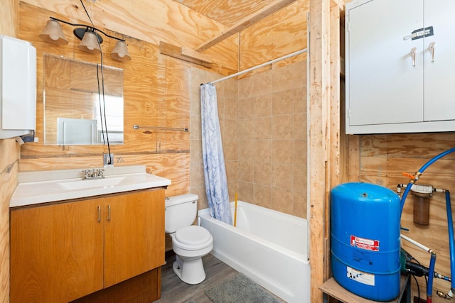 full bathroom with toilet, wood-type flooring, vanity, wooden walls, and shower / bath combo with shower curtain