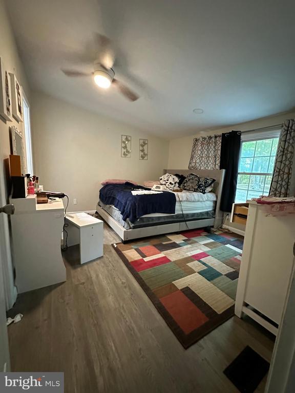 bedroom featuring dark hardwood / wood-style flooring and ceiling fan