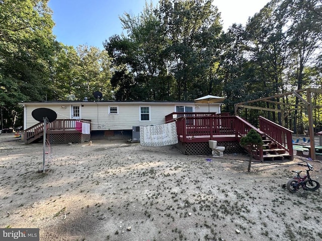 rear view of house with a wooden deck