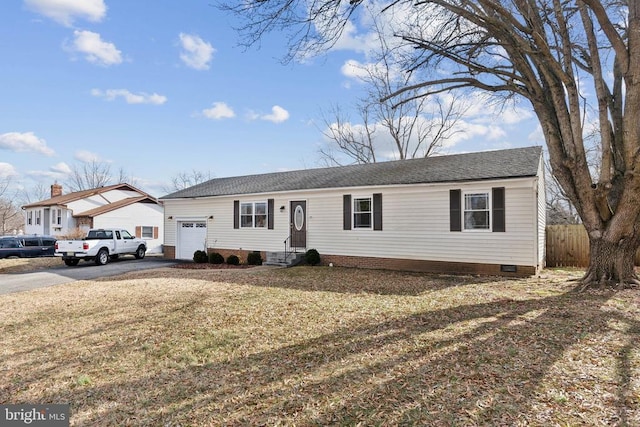 ranch-style home featuring aphalt driveway, an attached garage, fence, crawl space, and a front lawn