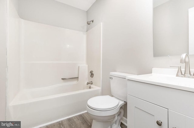 full bath featuring shower / bathing tub combination, vanity, toilet, and wood finished floors