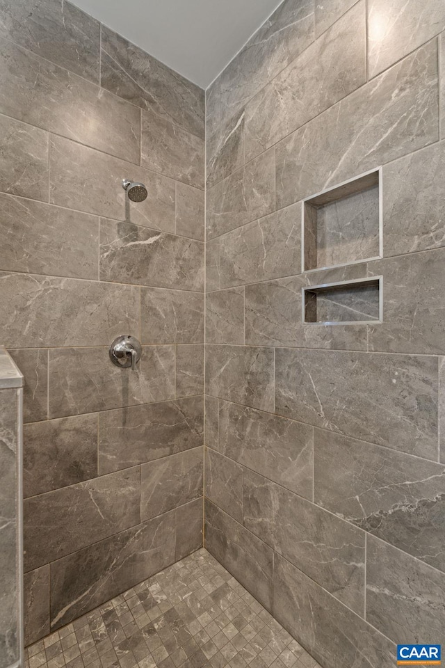 bathroom with a tile shower