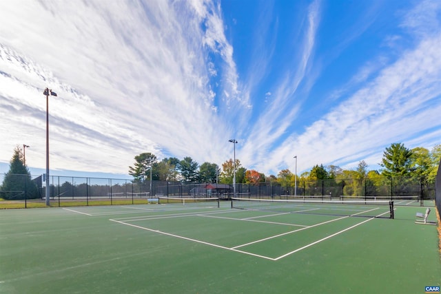 view of tennis court featuring fence