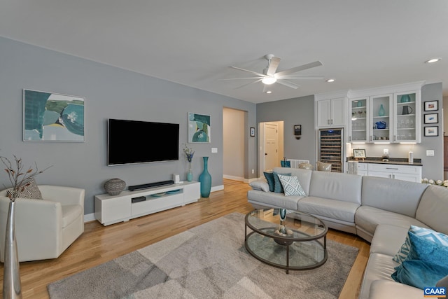 living area featuring recessed lighting, light wood-style flooring, baseboards, and ceiling fan